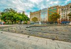 ein großer Platz in Barcelona mit Bäumen einem Springbrunnen und kreisförmig angelegte Pflastersteine