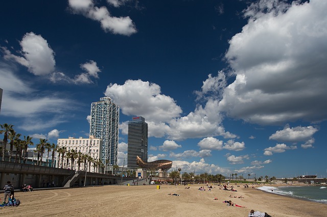 der Strand der Barceloneta mit Mensche die genüsslich in der Sonne liegen