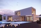 ein zweistöckiges fertigbauhaus in viereckigen formen mit einer überdachten Terrasse und einem Schwimmbad davor